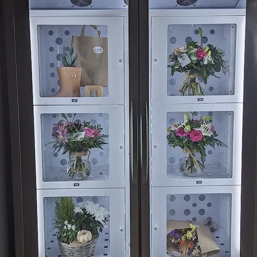 Close-up of bouquets and potted plants waiting in the machine's lockers